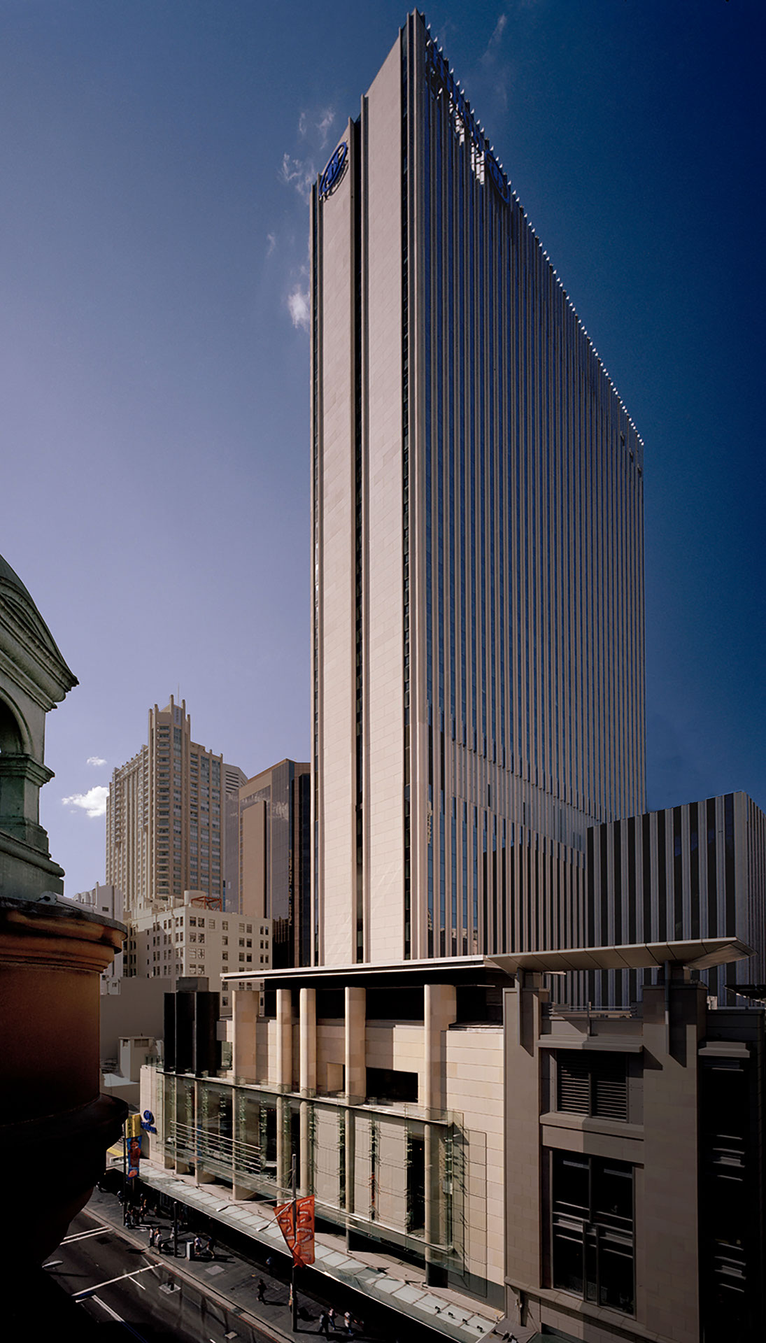 View from across the street of Hilton Sydney hotel, showcasing the building's scale and architectural facade.