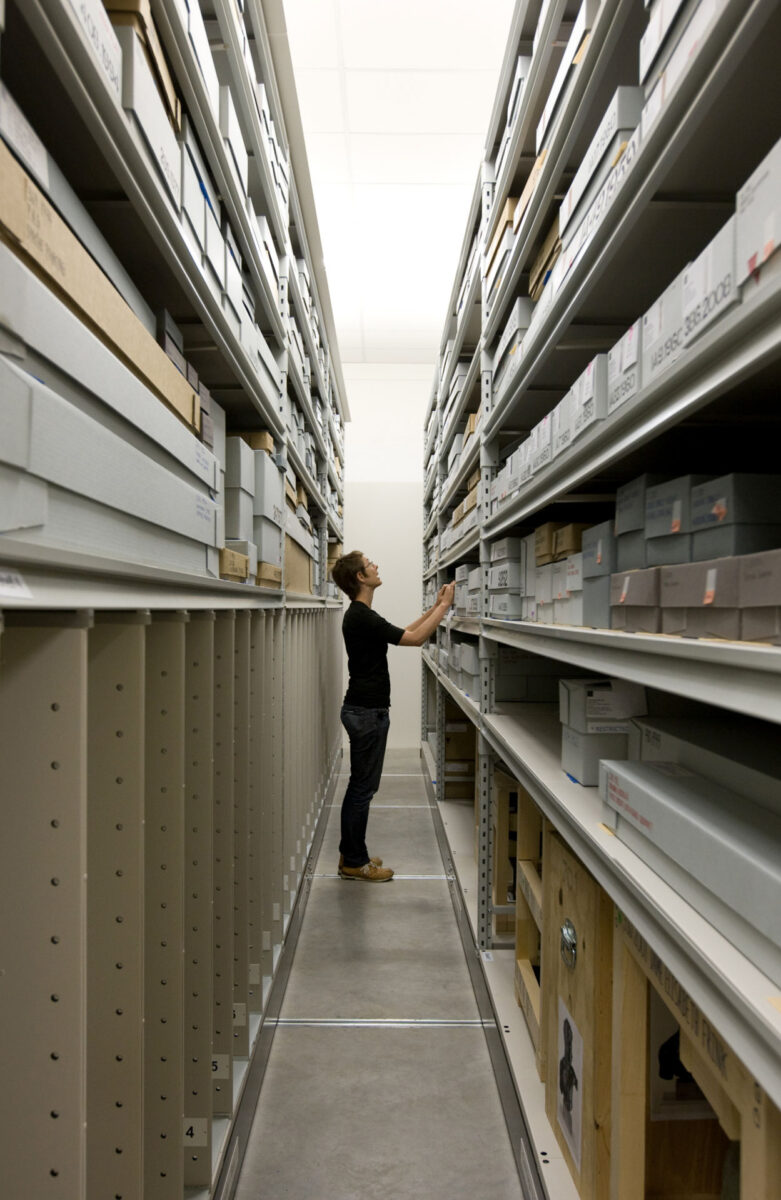 Interior view of Secure Art store shelving with a person in context.
